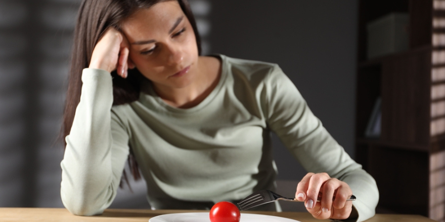 Sad woman thinking about food