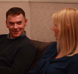 Man And Woman Talking On Sofa