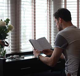 Man Reading Book At Desk